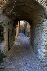 Fototapeta na wymiar Bussana Vecchia (IM), Italy - December 12, 2017: A typical house and pathway in Bussana Vecchia, Imperia, Liguria, Italy