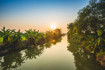 Fototapeta na wymiar Sunset over canal in Thailand
