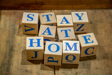 Wooden cubes with lettering Stay at Home in blue letters