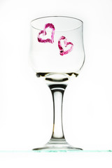 One glass with two heart  in red