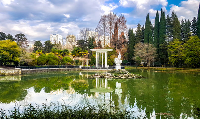 White gazebo and pond in arboretum of Sochi. Russia