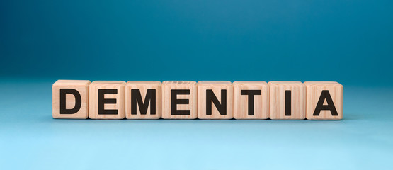 Dementia word cube on a blue background. Medical concept.