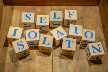 Wooden cubes with lettering Self-isolation in blue letters