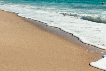 Deserted beach Sea waves overlook the sandy shore Summer background