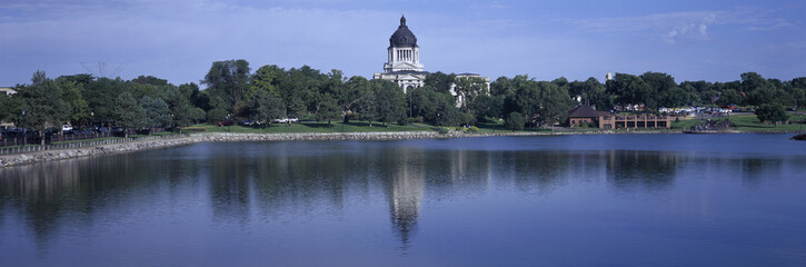 Fototapeta na wymiar Panoramic view of lake with view of South Dakota State Capitol and complex, Pierre, South Dakota, built between 1905 and 1910
