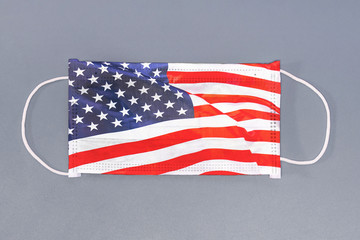 Isolated medical mask with flag of USA on gray background. Closeup protective masks textile filter....