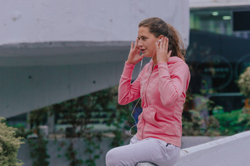 Young fitness woman taking a break outside in fitness workout