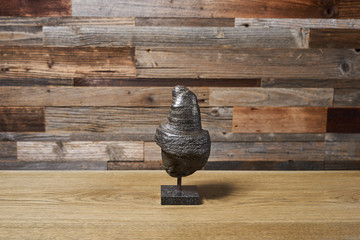 the mineral pyrite is a cylindrical figurine on a wooden background