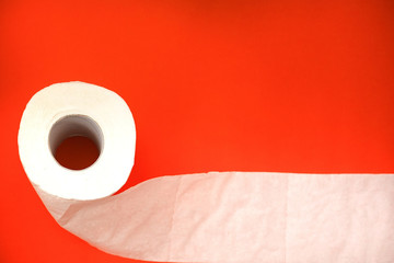 toilet paper on the scarlet background of the crisis