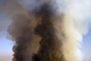 Brush fire in desert emitting large black plumes of smoke, east of Needles in Arizona