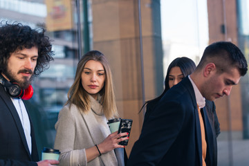 Group of diverse coworkers standing together and chatting..