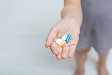 Hand with colorful pills on palm. Vitamins and antibiotics. Medication concept