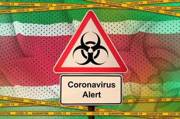 Suriname flag and Covid-19 biohazard symbol with quarantine orange tape. Coronavirus or 2019-nCov...