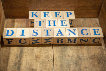 Wooden cubes with lettering Keep the Distance in blue letters