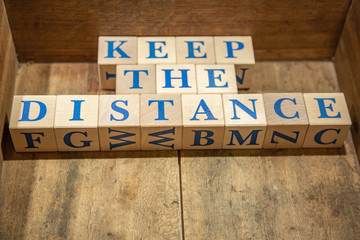 Wooden cubes with lettering Keep the Distance in blue letters
