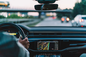 Male enjoying travel driving for exploring world steering rent car for crossing autobahn motorway,...