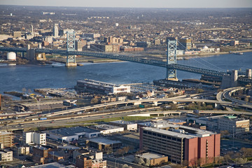 Fototapeta na wymiar Aerial view of Ben Franklin bridge crossing the Delaware River from Philadelphia, Pennsylvania side into Camden New Jersey