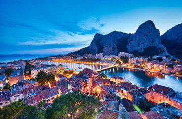 Fototapeta na wymiar Aerial panoramic view of Old town Omis: Ancient walls and red tiled roof. Croatia, Europe. One of best preserved medieval cities in the Mediterranean and most popular resorts of Adriatic Riviera.