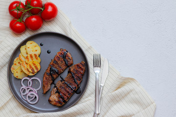 Pork steak with tomatoes . pork steak in home food concept on gray background top view . The menu design of the restaurant.