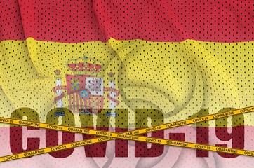 Spain flag and Covid-19 inscription with orange quarantine border tape. Coronavirus or 2019-nCov...