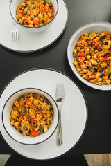 Morroccan couscous salad as a lunch on the table with cutlery 
