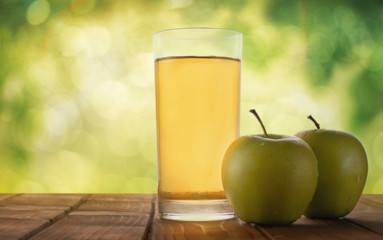 Apple juice on a table in the garden