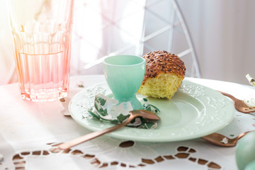 Breakfast leftovers. Egg shells and half-eaten brioche on a plate. Lifestyle image, natural light.