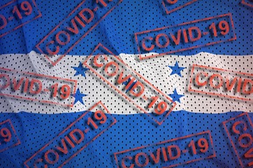 Honduras flag and many red Covid-19 stamps. Coronavirus or 2019-nCov virus concept
