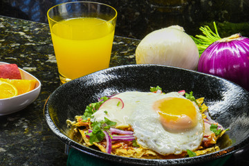 Red chilaquiles with fried egg a traditional Mexican breakfast.