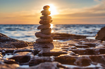 Fototapeta na wymiar Zen concept. Sunset. The object of the stones on the beach at sunset. Relax & Meditation. Zen stones.