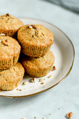 Healthy vegan snack carrot muffins cupcakes with brown sugar on the plate  chopped nuts