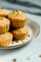 Healthy vegan snack carrot muffins cupcakes with brown sugar on the plate  chopped nuts