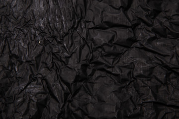 Black background. A crumpled texture. Close-up.