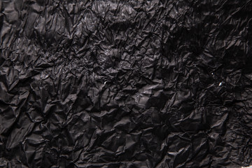 Black background. A crumpled texture. Close-up.