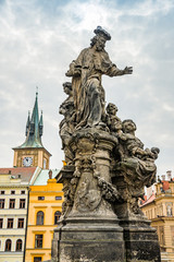 Fototapeta na wymiar Prague, Czech republic - March 19, 2020. Statues of Charles Bridge without tourist during travel ban