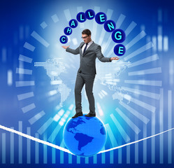 Businessman walking tight rop in challenge concept