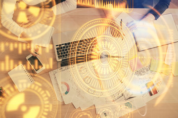 Double exposure of woman hands working on computer and tech theme hologram drawing. Top View. Technology concept.