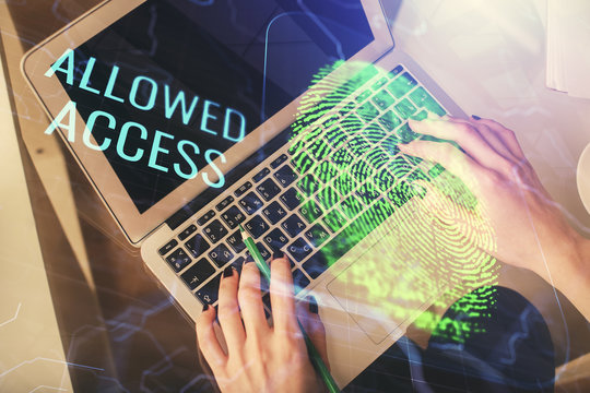 Double exposure of woman hands working on computer and fingerprint hologram drawing. Top View. Digital Security concept.