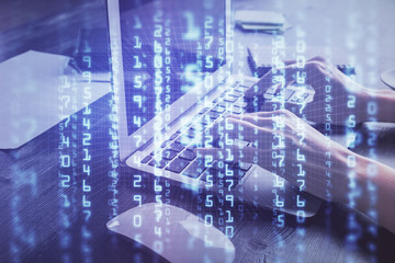 Double exposure of woman hands working on computer and data theme hologram drawing. Tech concept.