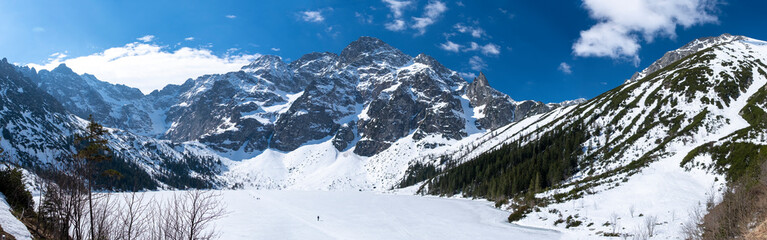 Fototapeta na wymiar A panoramic view over a frozen mountain lake (Morskie Oko) in the Tatra mountains