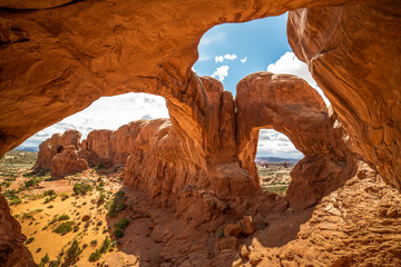 Stunning view of Double Arch in Arches National Park, Utah in the summertime with blue sky...