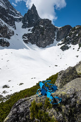 Blue crampons on the rock with high rocky mountains in the background