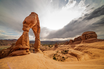 Delicate Arch in Arches National Park, Utah with wide panoramic landscape view at sunset. Grey,...