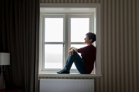 woman sitting in the window