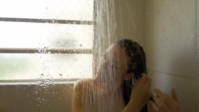 Closeup wet woman washing hair in bathroom