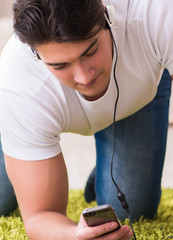 Young man student listening to music at home