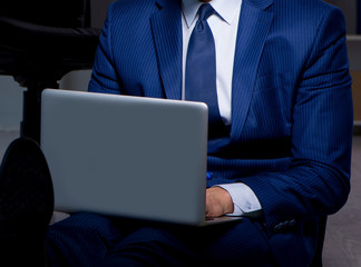 Businessman working overtime long hours late in office