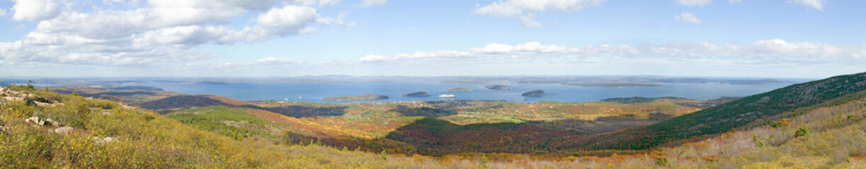 Panoramic autumn view from 1530 foot high Cadillac Mountain with views of the Porcupine Islands, Frenchman Bay and Holland America cruise ship in harbor, Acadia national Park, Maine