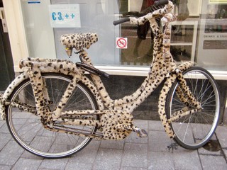 Fototapeta premium crazy leopard bicycle on the street, bicyle with leopard skin, mobility and transportation, amsterdam streets, amsterdam bycicle, amsterdam