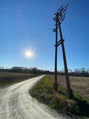 dirt road, power line, energy pylon, high voltage, field, sky, landscape, road, electricity, nature, power, rural, grass, energy, cable, country, line, green, pylon, blue, summer, countryside, wire
